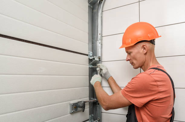 worker is installing lift gates in the garage. worker is installing lift gates in the garage.